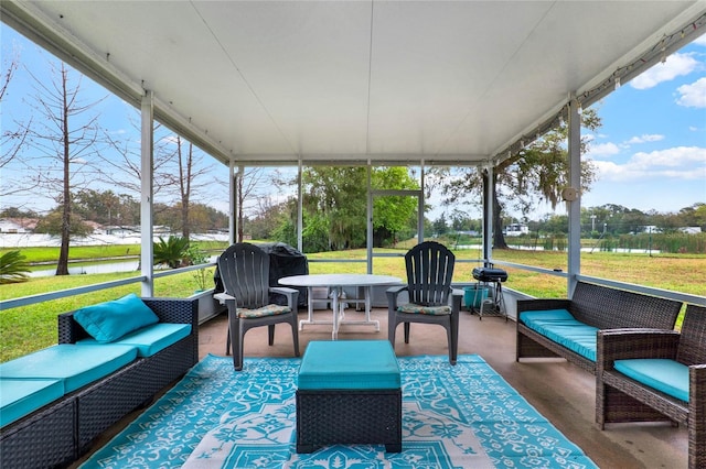 sunroom / solarium with a water view