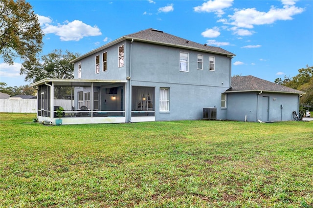 rear view of house featuring a sunroom, a yard, fence, and central AC unit