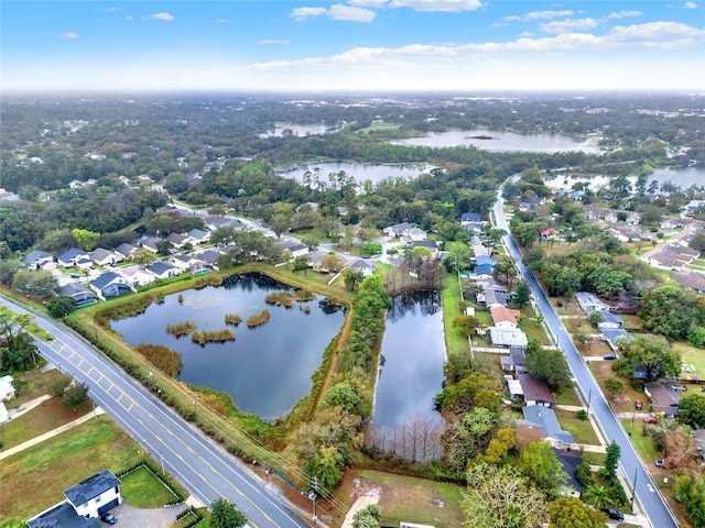 drone / aerial view with a water view and a residential view