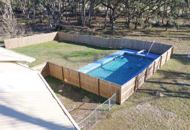 view of pool featuring a lawn and fence