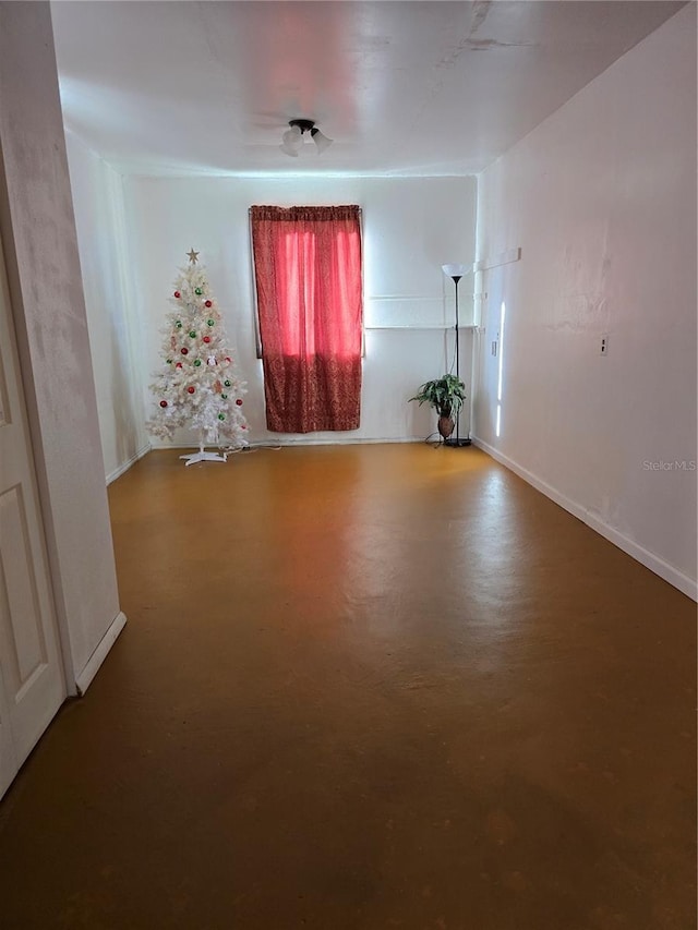 unfurnished room featuring concrete floors