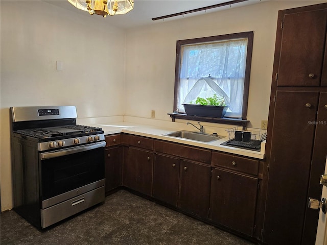 kitchen with a sink, dark brown cabinets, stainless steel range with gas stovetop, and light countertops