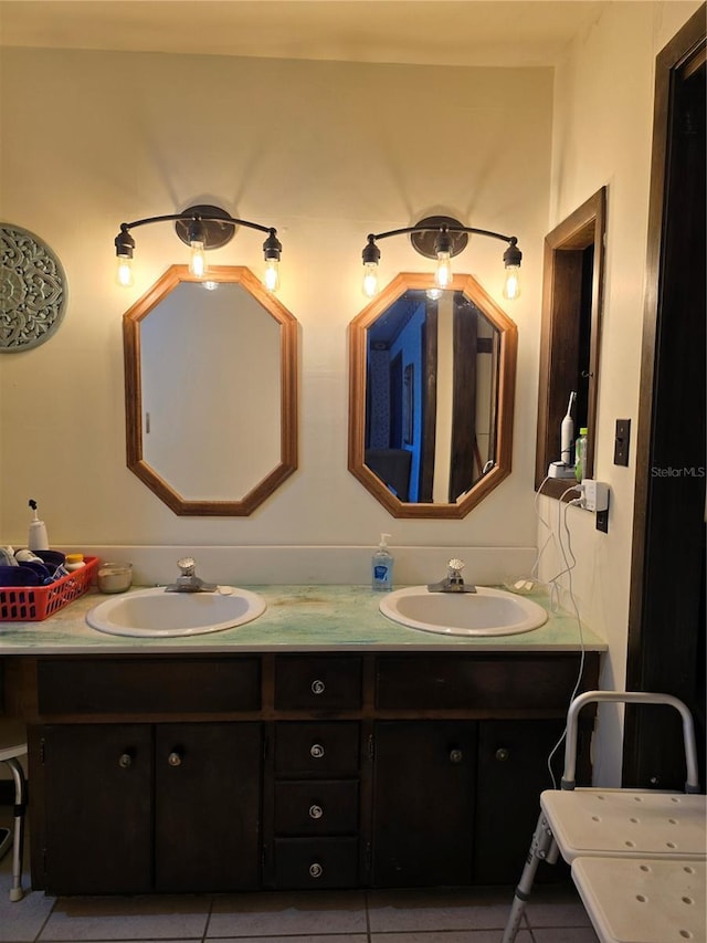 full bath featuring double vanity, a sink, and tile patterned floors