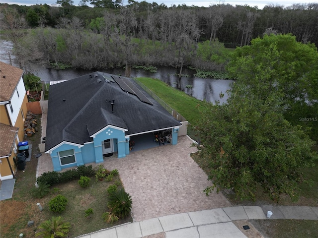 drone / aerial view featuring a water view and a view of trees