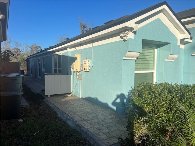 view of home's exterior featuring fence and stucco siding