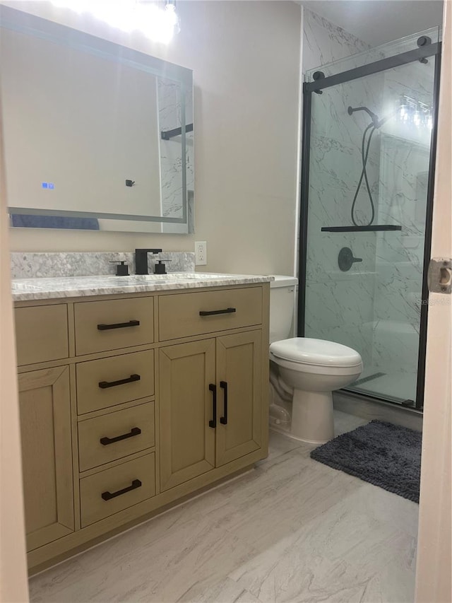 full bathroom with toilet, a marble finish shower, and vanity