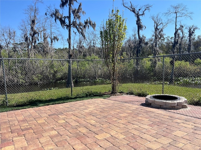 view of patio / terrace featuring a fire pit and fence