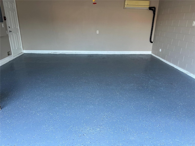 garage with concrete block wall and a wall mounted AC