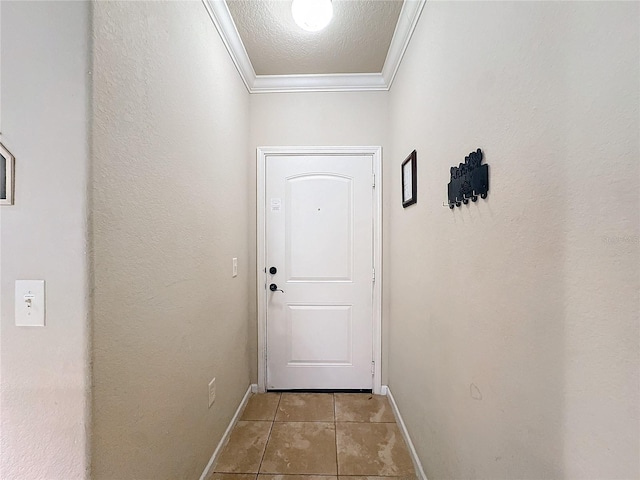 entryway featuring light tile patterned floors, ornamental molding, a textured ceiling, and baseboards