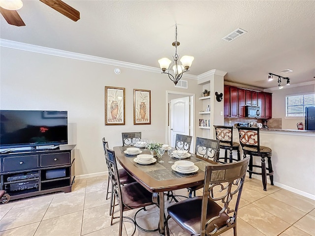 dining area featuring a textured ceiling, light tile patterned flooring, visible vents, and crown molding