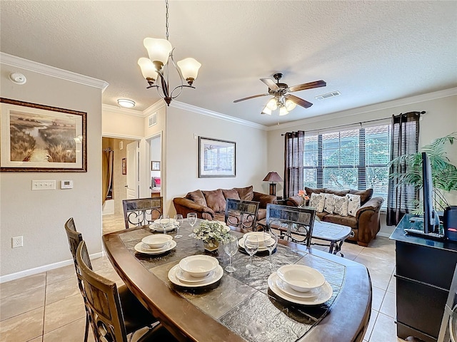 dining room featuring light tile patterned floors, a textured ceiling, visible vents, and crown molding