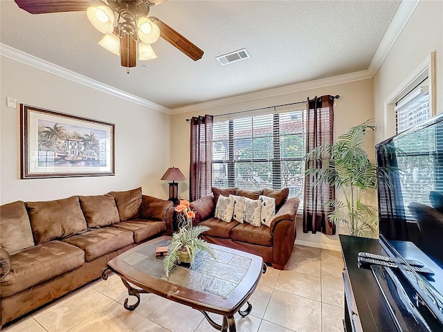 living room featuring visible vents, ornamental molding, and a textured ceiling