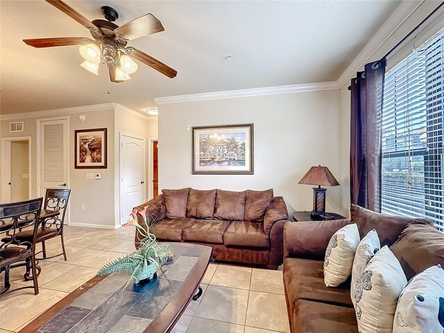 living room with light tile patterned flooring, visible vents, and crown molding