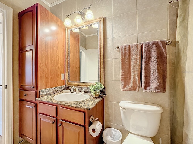 bathroom featuring ornamental molding, toilet, tile walls, and vanity