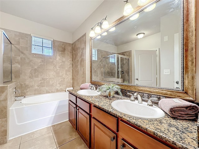 bathroom featuring tile patterned flooring, a sink, a shower stall, and double vanity