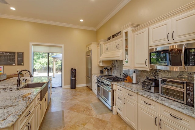 5719 Emerson Pointe Way, Orlando, FL 32819 - kitchen featuring baseboards, ornamental molding, high end appliances, and light stone countertops