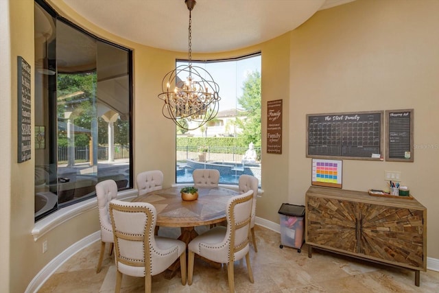 5719 Emerson Pointe Way, Orlando, FL 32819 - dining room with baseboards and a notable chandelier