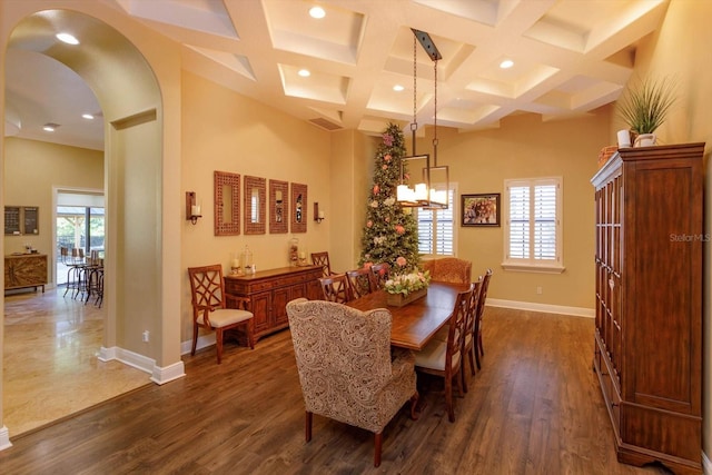 5719 Emerson Pointe Way, Orlando, FL 32819 - dining area featuring dark wood-type flooring, arched walkways, and a towering ceiling