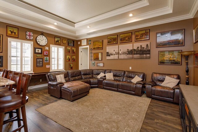 5719 Emerson Pointe Way, Orlando, FL 32819 - living room with dark wood-style floors, ornamental molding, a raised ceiling, and visible vents