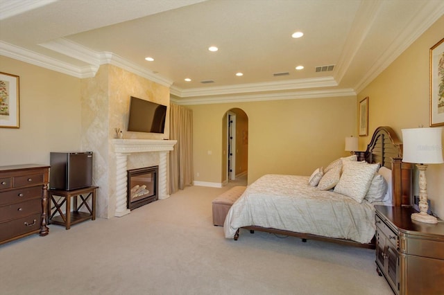 5719 Emerson Pointe Way, Orlando, FL 32819 - bedroom with light carpet, visible vents, arched walkways, a premium fireplace, and ornamental molding