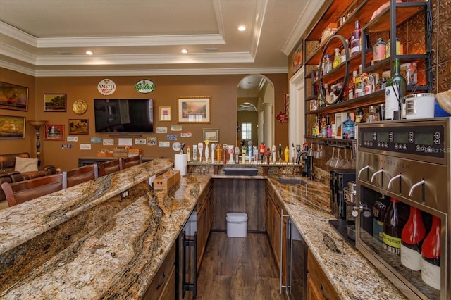 5719 Emerson Pointe Way, Orlando, FL 32819 - bar featuring dark wood-type flooring, indoor wet bar, a sink, and crown molding