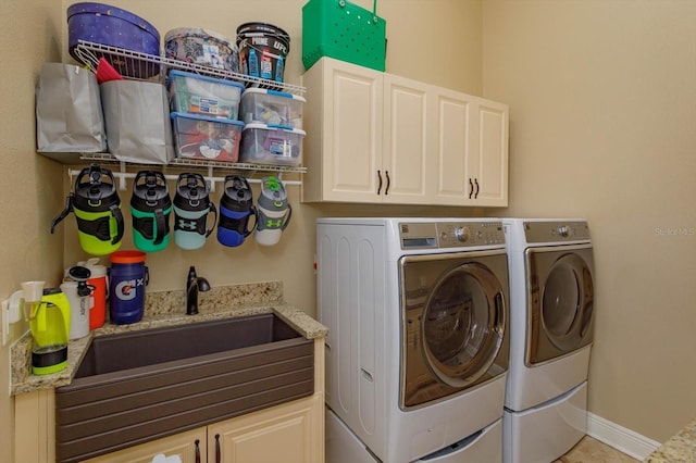 5719 Emerson Pointe Way, Orlando, FL 32819 - laundry area with a sink, washing machine and dryer, cabinet space, and baseboards