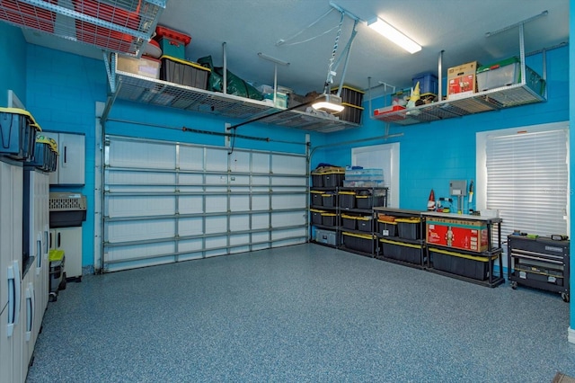 5719 Emerson Pointe Way, Orlando, FL 32819 - garage featuring concrete block wall and a garage door opener