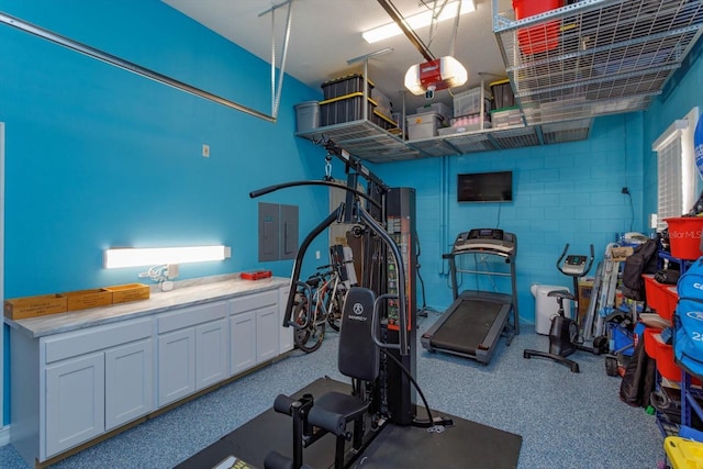 5719 Emerson Pointe Way, Orlando, FL 32819 - exercise area with a garage and concrete block wall