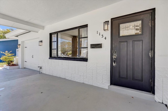 entrance to property featuring a garage