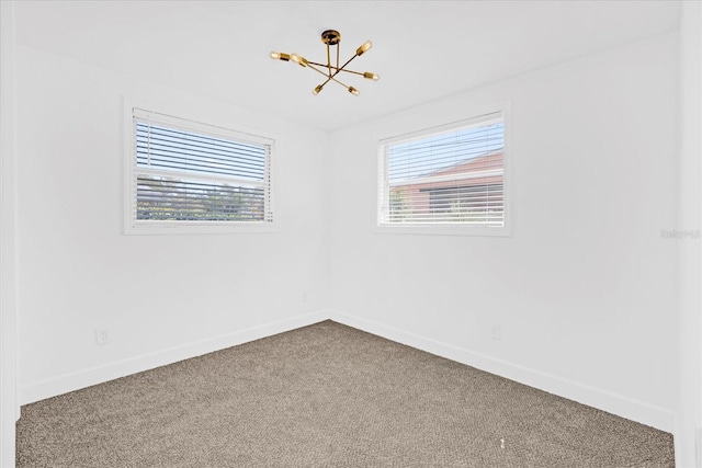 unfurnished room featuring carpet floors, plenty of natural light, and baseboards