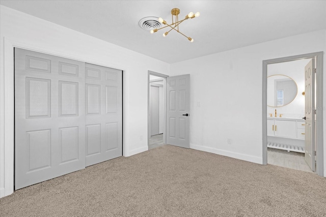 unfurnished bedroom featuring baseboards, a closet, carpet, and a notable chandelier