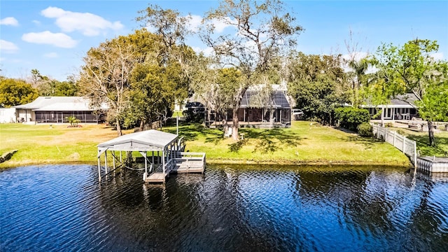 dock area with a yard, a water view, and boat lift