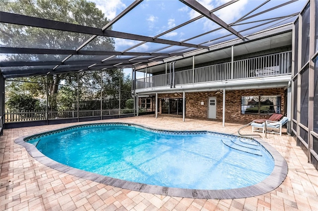 view of pool with a fenced in pool, glass enclosure, a patio area, and fence