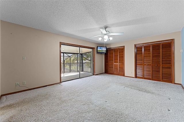 unfurnished bedroom with multiple closets, access to outside, baseboards, and carpet