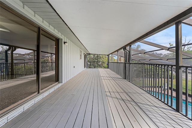 deck with glass enclosure and an outdoor pool