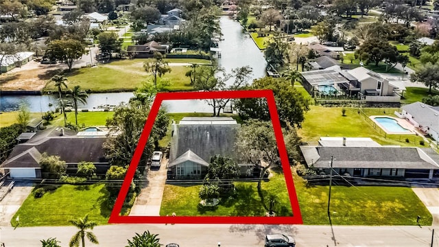 birds eye view of property featuring a water view and a residential view