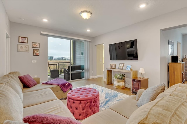 living room featuring light wood-style floors, baseboards, and recessed lighting