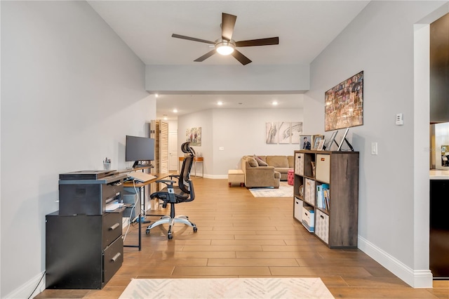 office featuring ceiling fan, baseboards, and wood finished floors