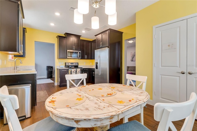 dining area with dark wood-style floors, visible vents, baseboards, and recessed lighting