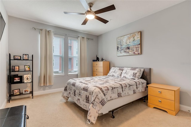 bedroom featuring light carpet, baseboards, and a ceiling fan