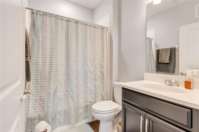 full bath featuring visible vents, vanity, and toilet