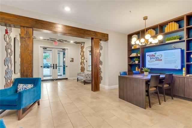 welcome area featuring a chandelier and french doors