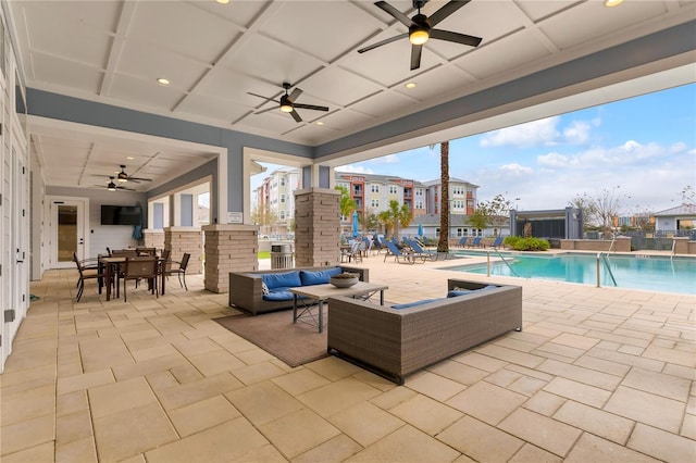 view of patio with ceiling fan, a community pool, outdoor lounge area, and outdoor dining space