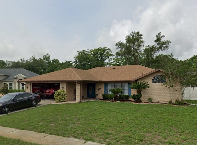 ranch-style house with concrete driveway, a front lawn, an attached garage, and brick siding