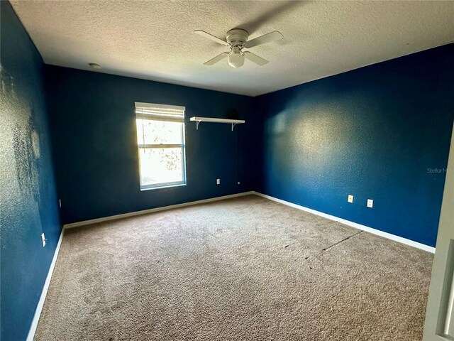 2143 Tealwood Cir, Tavares, FL 32778 - carpeted empty room with a ceiling fan, a textured wall, a textured ceiling, and baseboards