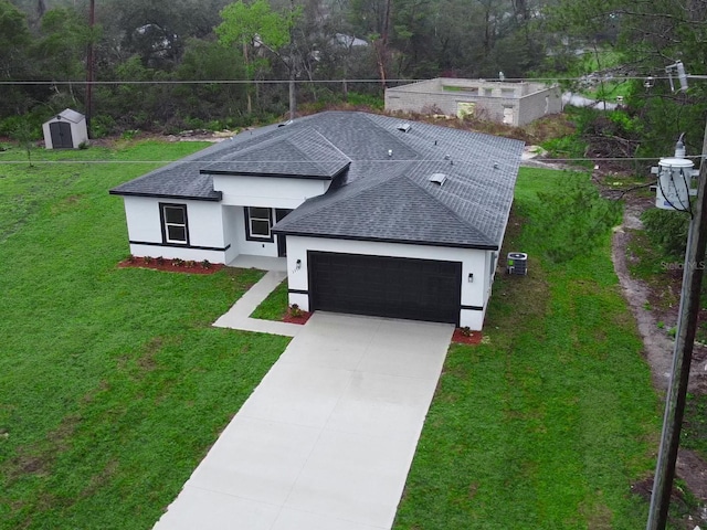 single story home featuring a garage, roof with shingles, and a front yard