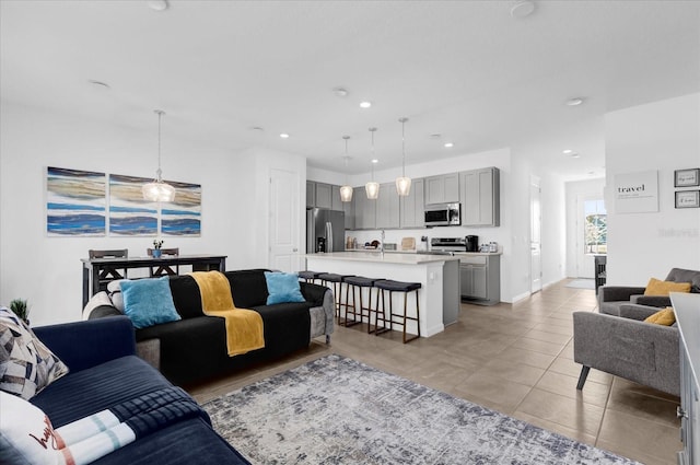 living area featuring light tile patterned floors, baseboards, and recessed lighting