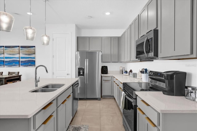 kitchen featuring light tile patterned floors, stainless steel appliances, light countertops, gray cabinetry, and a sink