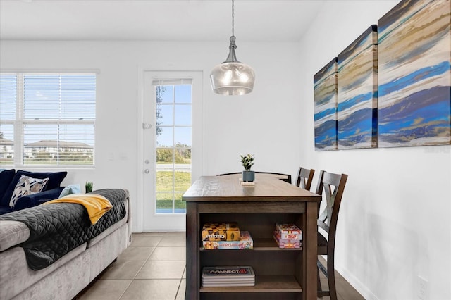 dining space featuring baseboards and tile patterned floors