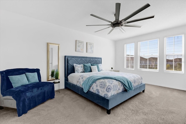 carpeted bedroom featuring a ceiling fan and baseboards